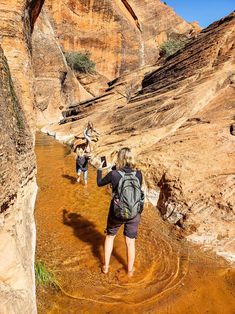 two people are hiking through the desert in their backpacks