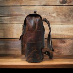 Classic leather laptop backpack for work. Durable, functional design for professionals. Get organized and stay stylish on the go. - Free shipping on all our leather backpacks - Dimensions: 12 x 16 x 5 inches || 30 x 40 x 13 cm (L x H x W) - Crafted from premium quality cowhide leather - Polyester lining - Features 2 spacious compartments for books, files, and a laptop; one compartment is padded for laptop protection - Three outer pockets: two on sides and one in middle - Adjustable shoulder straps for comfort - Rust-free brass accessories used throughout - Precisely crafted with attention to detail by our team for a perfect product - It takes approx seven to ten business days to complete each leather backpack. - As each leather is unique in finishing, the leather backpack you will receive Leather Office Backpack, Office Standard Backpack In Soft Leather, Office Soft Leather Standard Backpack, Leather Laptop Bag Standard Backpack For Daily Use, Leather Laptop Bag For Daily Use, Soft Leather Office Backpack, Office Leather Backpack, On-the-go Leather Laptop Backpack, Business Backpack With Waxed Finish