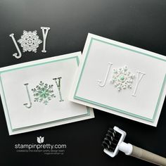 two cards with snowflakes and the word joy on them