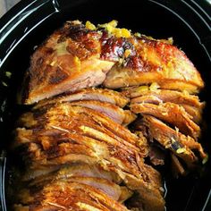 sliced meat in a slow cooker on a table