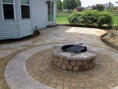 an outdoor patio with a fire pit in the middle