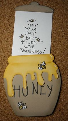 a honey jar with some bees on it and a note attached to the lid that says honey