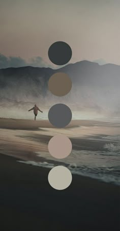 a man standing on top of a beach next to the ocean