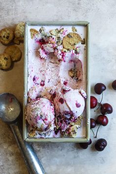 an ice cream dish with cherries and cookies