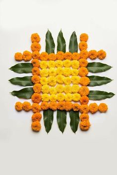 an arrangement of orange and yellow flowers arranged in the shape of a square stock photo