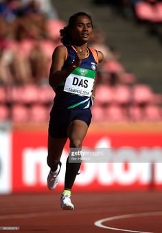 a woman running on a track during a race