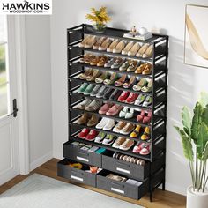 a black shoe rack filled with lots of pairs of shoes next to a potted plant