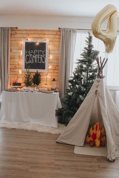 a teepee tent in front of a christmas tree