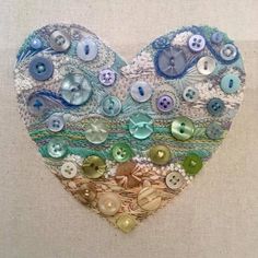 a heart made out of buttons and lace