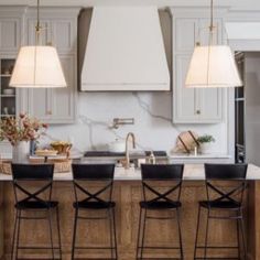 an image of a kitchen setting with four chairs and two lamps on the counter top