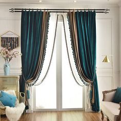 a living room filled with furniture and a large window covered in blue drapes next to a wooden floor