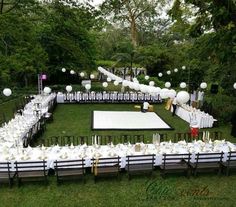 an outdoor party setup with tables and chairs