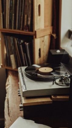 a record player sitting on top of a wooden table