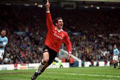 a soccer player is celebrating his goal in front of the crowd as he runs towards the camera