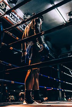 a man standing on top of a wrestling ring