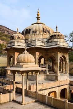 an old building with many pillars and domes