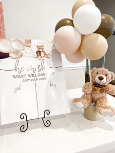 a teddy bear and some balloons on a table