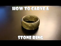 a stone ring sitting on top of a table next to the words how to carve a stone ring