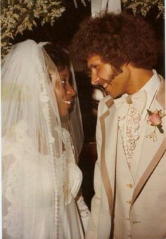 the bride and groom are smiling at each other