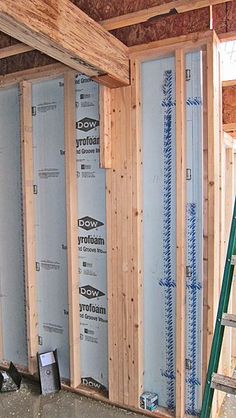 the inside of a house being built with wooden framing and insulations on the walls