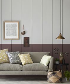 a living room filled with furniture and pillows on top of a couch next to a table