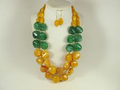 "Contains small parts! Not for children! Choking Hazard!Chunky gold yellow marigold  and forest green necklace, multi strand statement yellow necklace, beaded yellow necklace, big gold  beads, green  statement jewelry, matching earrings  A bold and dramatic statement necklace featuring acrylic forest green chip  beads and huge marigold  yellow  oval beads. 3 strands, light weight. Gold  plated lobster clasp Measurements: 19\" (47 cm) plus 3\" extender Each piece of jewelry from my shop comes bea Handmade Yellow Double Strand Jewelry, Handmade Double Strand Yellow Necklace, Handmade Yellow Double Strand Necklace, Yellow Marigold, Jewelry Matching, Marigold Yellow, Necklace Big, Yellow Necklace, Oval Beads