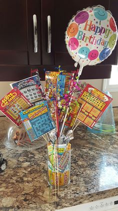 a birthday party decoration in a vase on the kitchen counter