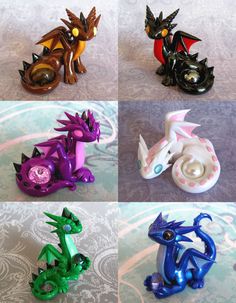 four different types of dragon figurines sitting on a table