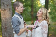 a man holding a stethoscope next to a woman in a white dress