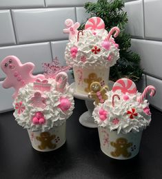 three cupcakes decorated with pink and white icing