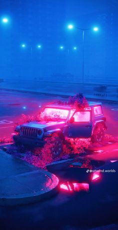 a jeep is parked on the side of the road in front of some bushes and lights