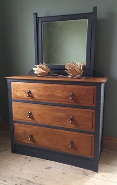 a dresser with a mirror on top of it and some drawers in front of it