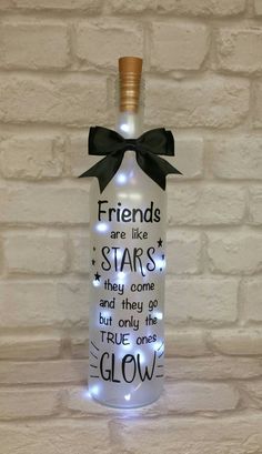 a bottle that has some lights in it and is decorated with words on the side