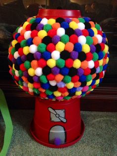 a red machine with multi colored balls on it