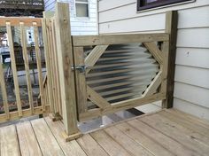 a wooden deck with a metal gate on it