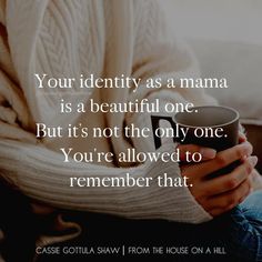 a person holding a coffee cup with the words your identity as a mama is a beautiful one but it's not the only one you're allowed to remember that