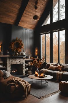 a living room filled with furniture and a fire place in front of a large window