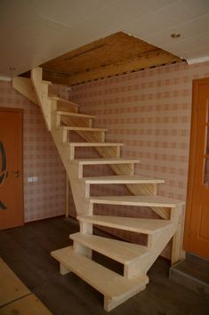 there is a wooden staircase in the room