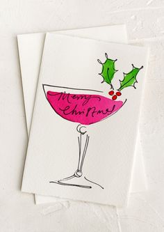 two christmas cards with the words merry christmas written in red and green ink on white paper