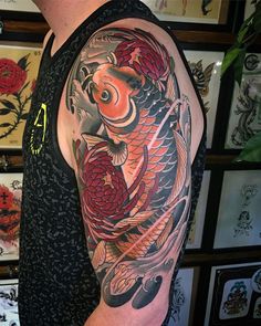 a man with a tattoo on his arm has a koi fish in the water