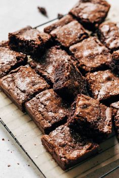 chocolate brownies on a cooling rack with powdered sugar