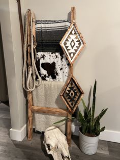 a cow skull is sitting on the floor next to a towel rack and other items