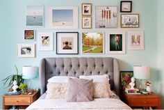 a bedroom with blue walls and pictures on the wall