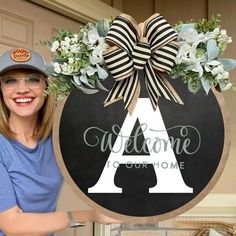 a woman standing in front of a welcome sign