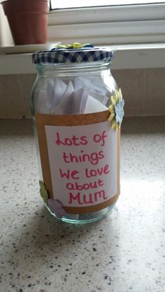 a jar filled with lots of things sitting on top of a counter