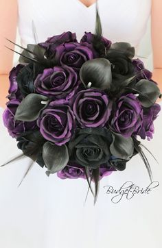 a bride holding a purple and black bouquet