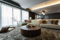 a living room filled with lots of furniture and pillows on top of a shaggy rug