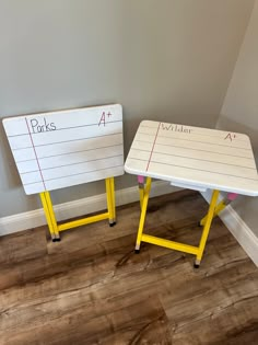 two tables with writing on them sitting in a room next to each other, one is yellow and the other is white