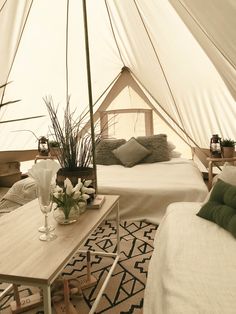 a bed and table in a room with a tent