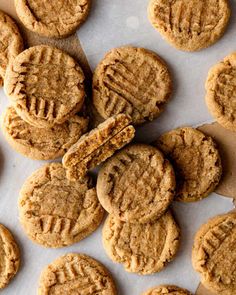 peanut butter cookies are arranged on a sheet of parchment paper